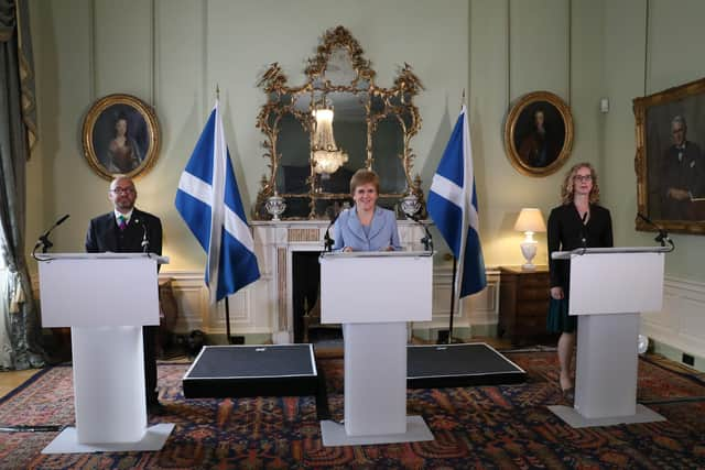 Nicola Sturgeon announces the new government deal, flanked by Green co-leaders Patrick Harvie and Lorna Slater