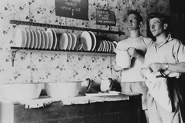 Students dry the dishes after a communal dinner on the island. PIC: David Andrewes reproduced from Scottish Islands Explorer magazine.