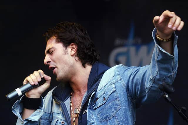 Darius Danesh performs on stage at the "IKEA Bristol International Balloon Fiesta Concert" launching the 26th annual and largest balloon fiesta outside US, at the Ashton Court Estate, on August 12, 2004 in Bristol, England.  (Photo by Matt Cardy/Getty Images)