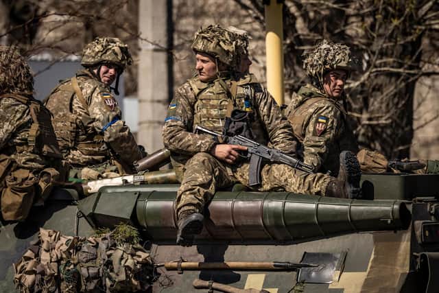 Ukrainian soldiers sit on an armoured military vehicle in the frontline city of Severodonetsk, Donbas region, last month (Picture: Fadel Senna/AFP via Getty Images)