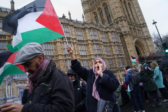 People take part in a Palestine Solidarity Campaign rally outside the Houses of Parliament, London, as MPs debate calls for a ceasefire in Gaza. Photo: Lucy North/PA Wire