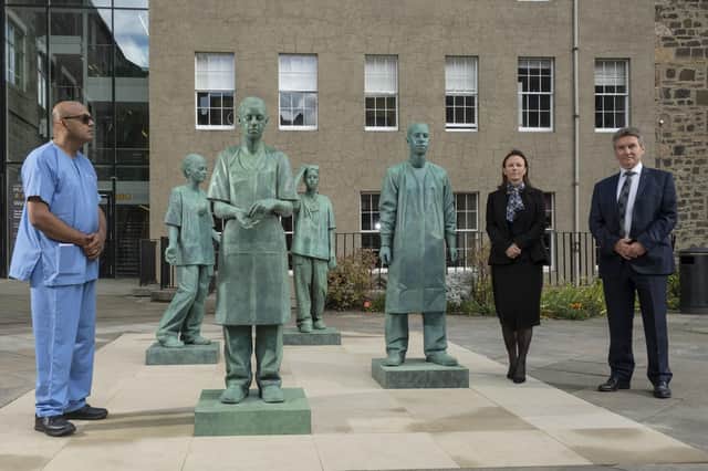 (L-R) Nirmal Kumar, Clare McNaught, Professor Michael Griffin at an unveiling of  a new sculpture which they helped to inspire at the Royal College of Surgeons of Edinburgh grounds