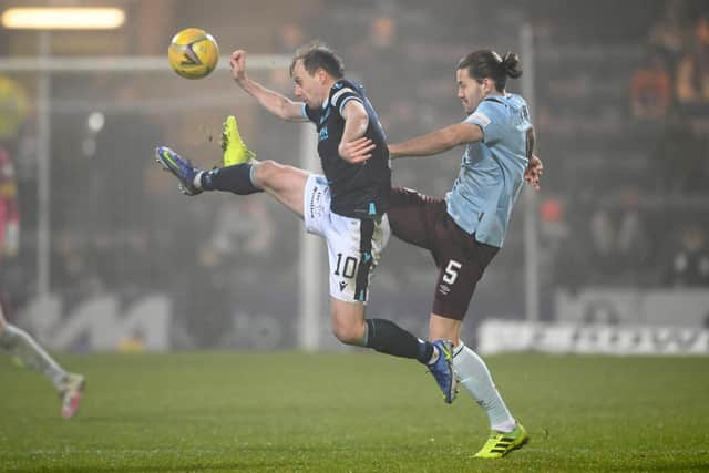 Paul McGowan challenges Hearts' Peter Haring as Dundee lost for the fourth successive league match.