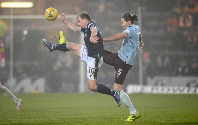Paul McGowan challenges Hearts' Peter Haring as Dundee lost for the fourth successive league match.