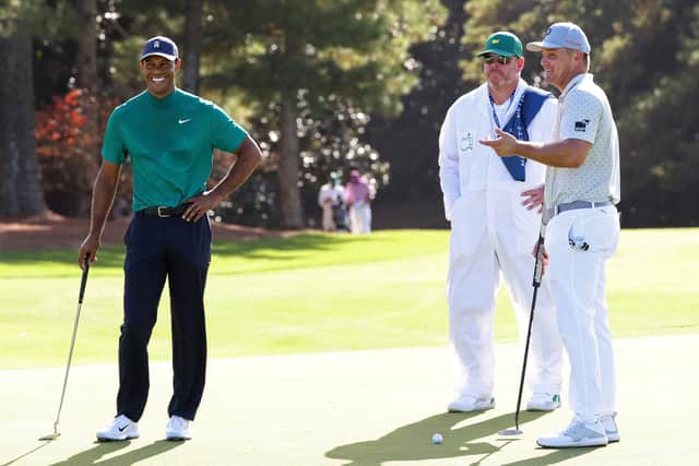 Bryson DeChambeau and Tiger Woods of the United States talk on the 18th green at Augusta National. Picture: Jamie Squire/Getty Images