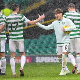 Kyogo Furuhashi embraces team-mate Ryan Christie as he cradles the match ball following his hat-trick against Dundee. Picture: SNS
