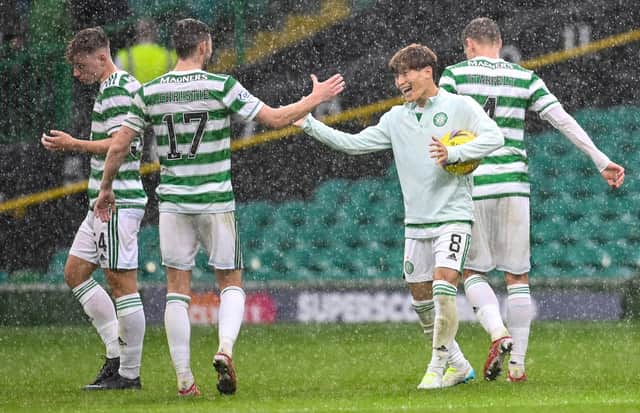 Kyogo Furuhashi embraces team-mate Ryan Christie as he cradles the match ball following his hat-trick against Dundee. Picture: SNS