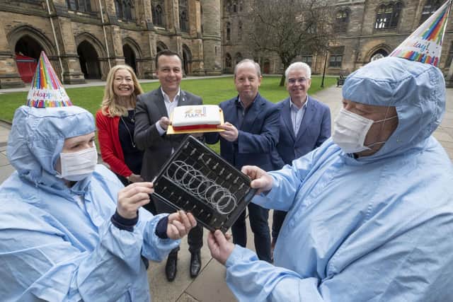 JWNC director of strategy Evelyn Toma, JWNC director Professor Martin Weides, Sivers Semiconductor CTO Andrew McKee, and Kelvin Nanotechnology CEO Brendan Casey are flanked by JWNC staff in cleanroom suits holding laser components. Picture: University of Glasgow / Chris James