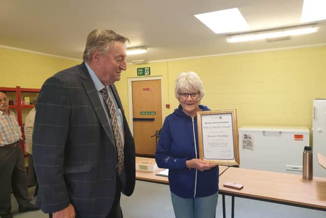 Councillor Hall presents Rosemary with the award.