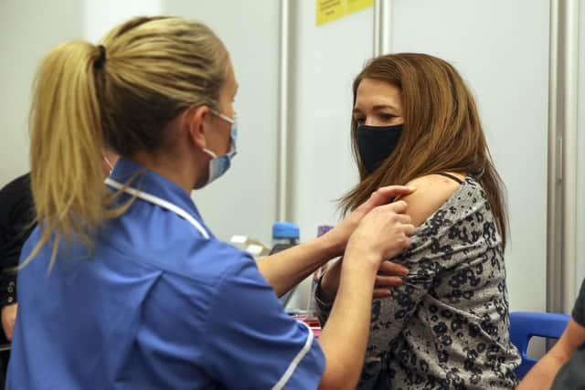 Caroline Nicolls receive an injection of the Moderna Covid-19 vaccine administered by nurse Amy Nash.