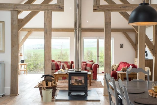 Both the sitting room and dining room benefit from a double sided central log burning stove.