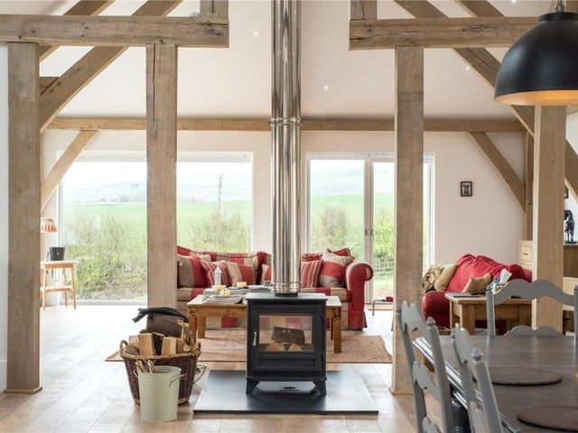 Both the sitting room and dining room benefit from a double sided central log burning stove.