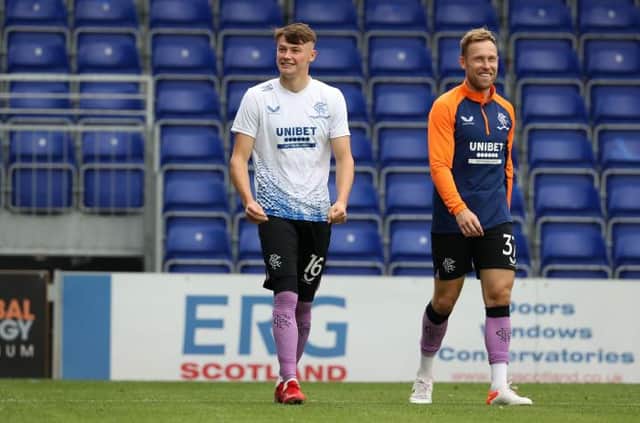 Nathan Patterson (left), an unused substitute for Rangers' match against Ross County on Sunday, pictured warming up with Scott Arfield (right). (Photo by Alan Harvey / SNS Group)