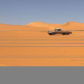 A vehicle drives along a dune in the Sabha district, in southwestern Libya, which is believed to be close to the site where the missing uranium has disappeared from.