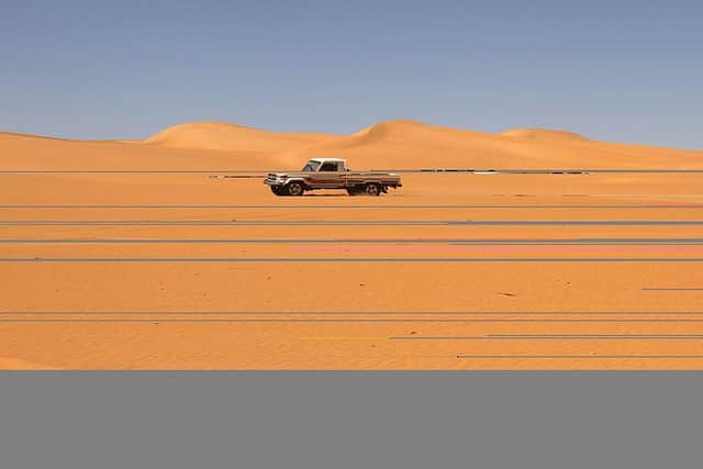 A vehicle drives along a dune in the Sabha district, in southwestern Libya, which is believed to be close to the site where the missing uranium has disappeared from.
