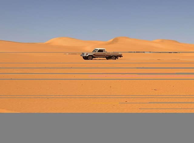 A vehicle drives along a dune in the Sabha district, in southwestern Libya, which is believed to be close to the site where the missing uranium has disappeared from.