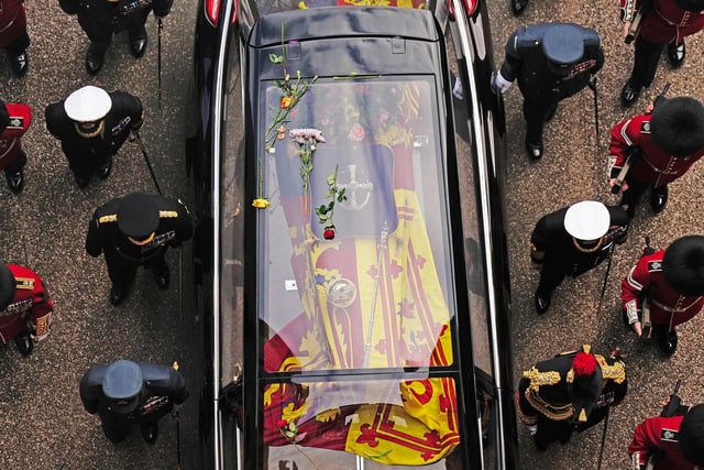 Flowers on the hearse carrying the coffin of Queen Elizabeth II as it arrives at Windsor Castle for the Committal Service in St George's Chapel. Picture date: Monday September 19, 2022.