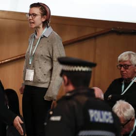 A protestor from This Is Rigged is led away from the chamber during First Minister's Questions. Picture: Getty Images