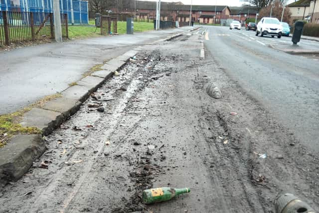 Debris in a cycle lane in Bilsland Drive in the Ruchill area of north Glasgow – complete with an empty Buckfast bottle (Picture: The Scotsman)