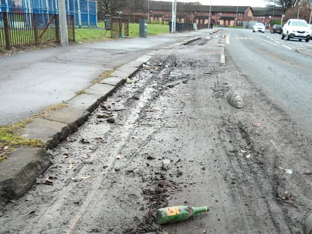 Debris in a cycle lane in Bilsland Drive in the Ruchill area of north Glasgow – complete with an empty Buckfast bottle (Picture: The Scotsman)