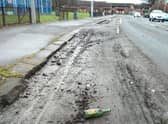 Debris in a cycle lane in Bilsland Drive in the Ruchill area of north Glasgow – complete with an empty Buckfast bottle (Picture: The Scotsman)