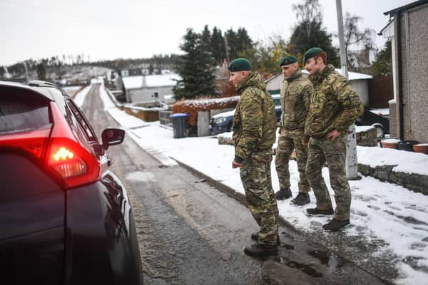 Marines from 45 Commando carry out welfare checks in Lumphanan, after Storm Arwen left many people without power (Picture: Peter Summers/Getty Images)