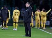 Celtic manager Ange Postecoglou is left dejected as Bodo/Glimt celebrate their Europa Conference League first leg win at Celtic Park last week. (Photo by Craig Williamson / SNS Group)