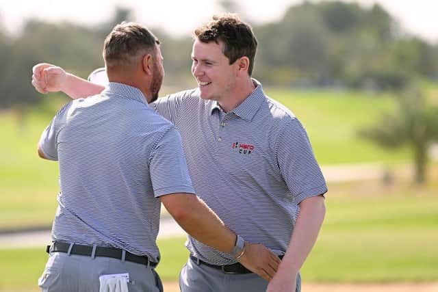 Jordan Smith and Bob Macintyre celebrates after winning their morning foursomes on day two of the Hero Cup at Abu Dhabi Golf Club. Picture: Ross Kinnaird/Getty Images.