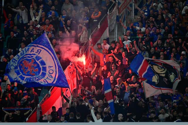 Rangers fans light flares prior to the UEFA Europa League semi-final first leg against RB Leipzig in Germany. (Photo by JOHN MACDOUGALL/AFP via Getty Images)