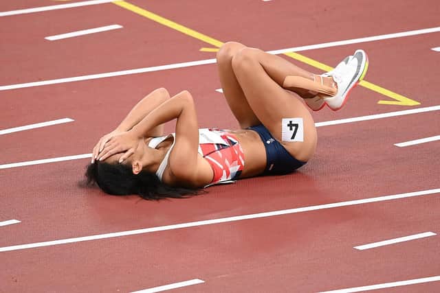 Johnson-Thompson lies injured on the track at the Olympic Stadium in Tokyo. Picture: Matthias Hangst/Getty Images