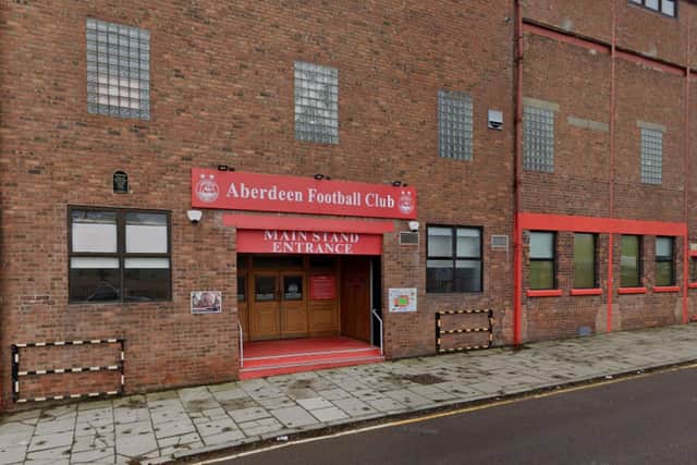 A man has been arrested and charged in connection with an assault which happened at the home grounds of Aberdeen Football Club in August.