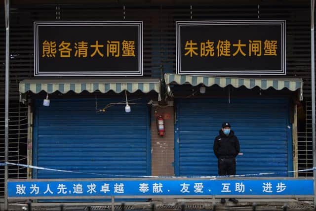 A security guard stands outside the Huanan Seafood Wholesale Market where the coronavirus was detected in Wuhan (Photo: HECTOR RETAMAL/AFP via Getty Images)