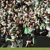 Kyogo Furuhashi takes the acclaim of the Celtic support after netting his second of the game against Rangers.