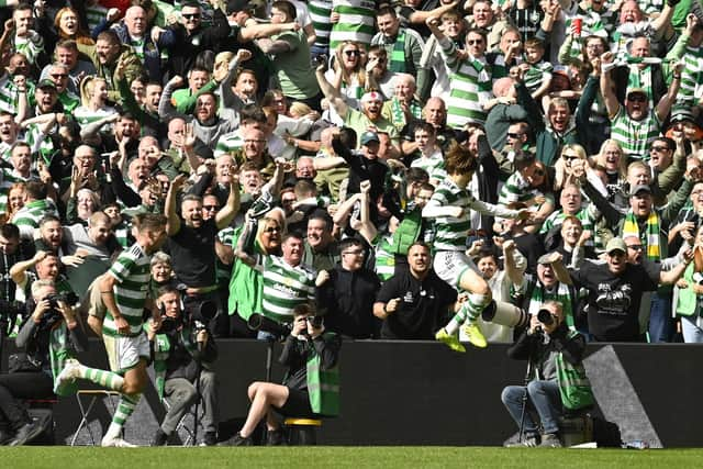 Kyogo Furuhashi takes the acclaim of the Celtic support after netting his second of the game against Rangers.