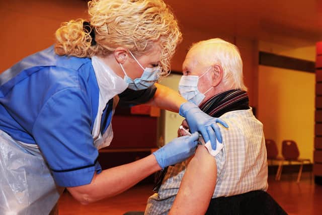 An immunisation staff nurse gives a does of the Pfizer vaccine to patient John Shepherd from Camelon. Picture: Michael Gillen