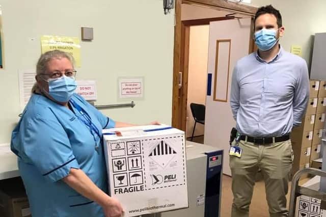 Senior Pharmacy Technician Christine Sinclair and Chief Pharmacist Liam Callaghan with the first box of the Covid-19 vaccine in the Western Isles.