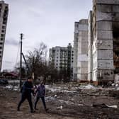 Local people walk in front of flats that were hit by Russian shells in the city of Chernihiv on March 3. Forty-seven people were killed (Picture: Dimitar Dilkoff/AFP via Getty Images)