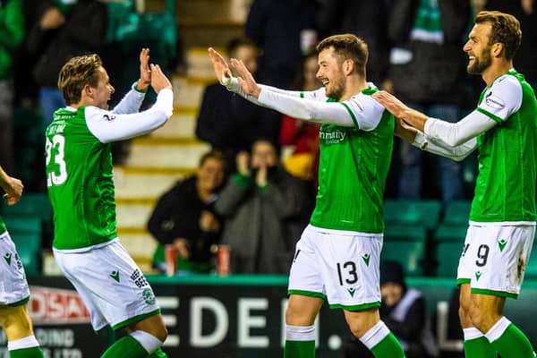 Hibs' Marc McNulty is congratulated by Scott Allan (L) after making it 1-0 during a Ladbrokes Premiership match between Hibernian and Ross County at Easter Road on February 12