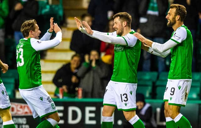 Hibs' Marc McNulty is congratulated by Scott Allan (L) after making it 1-0 during a Ladbrokes Premiership match between Hibernian and Ross County at Easter Road on February 12