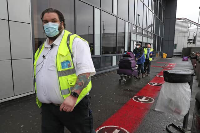 Chun Wong and his daughter Kiernan, 8, leave Edinburgh airport after entering the country on the first day that travellers flying directly into Scotland on international flights have to self-isolate for 10 days in a quarantine hotel room.