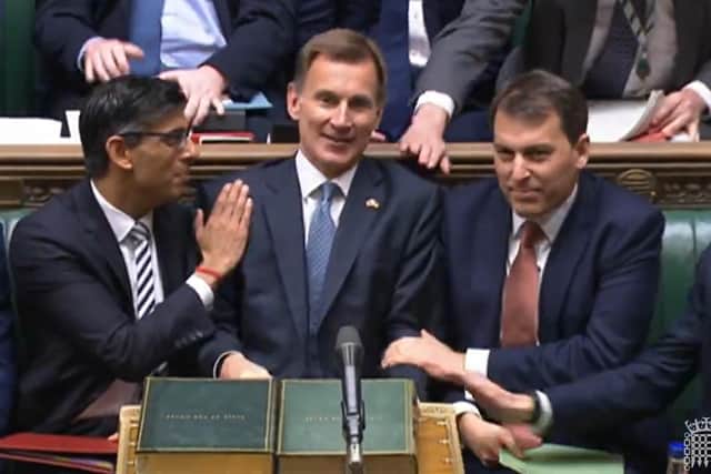 Prime Minister Rishi Sunak congratulates Chancellor of the Exchequer Jeremy Hunt after he delivered his autumn statement to MPs.