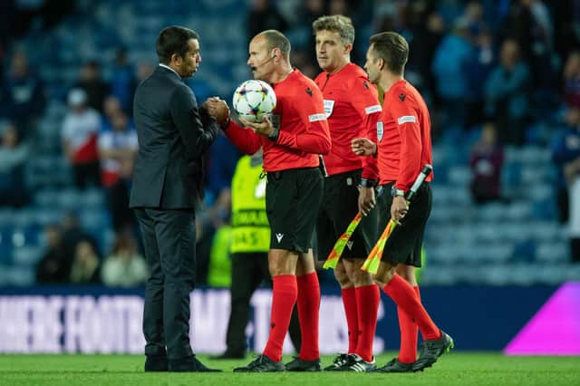 Rangers manager Giovanni Van Bronckhorst speaks to Antonio Miguel Mateu Lahoz after the Spanish referee's controversial performance at Ibrox (Photo by Craig Foy / SNS Group)