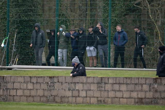 Fans watch on from outside Stair Park.