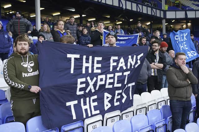 Fans protest against the Everton board after the English Premier League soccer match between Everton and Aston Villa at the Goodison Park stadium, in Liverpool, England, Saturday Jan. 22, 2022. (AP Photo/Jon Super)