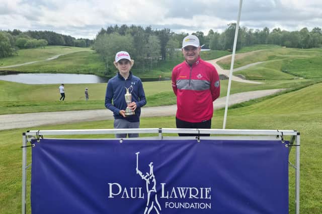 Blairgowrie's Cnnor Graham shows off the Junior Claret Jug after being presented with it by Paul Lawrie at Newmachar. Picture: Paul Lawrie Foundation