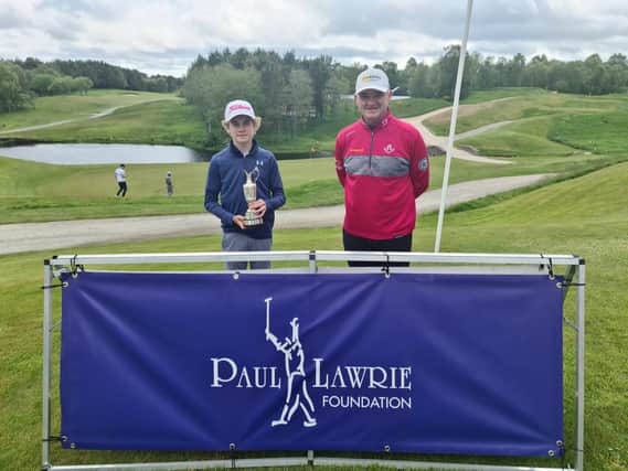 Blairgowrie's Cnnor Graham shows off the Junior Claret Jug after being presented with it by Paul Lawrie at Newmachar. Picture: Paul Lawrie Foundation
