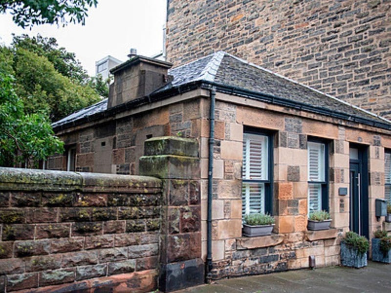 The exterior of the property contains clues to its former use - including graffiti on the garden walls.