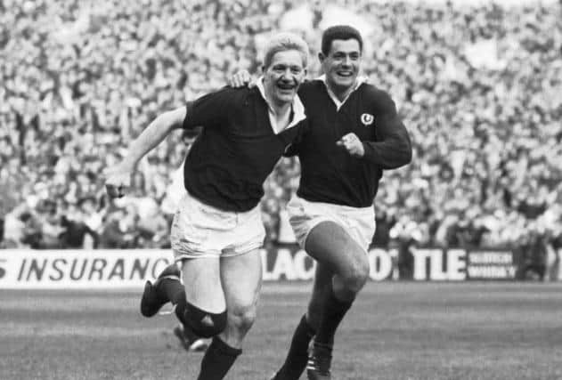 A delighted John Jeffrey and Gavin Hastings leave the field after their 13-7 Calcutta Cup win over England in the Five Nations rugby tournament, March 1990.