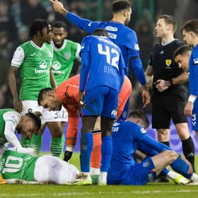 Hibs' Martin Boyle goes down injured after colliding with Rangers' John Souttar.