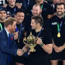 Prince Harry presents New Zealand captain Richie McCaw with the Webb Ellis Trophy after the All Blacks' victory over Australia in the 2015 Rugby World Cup final at Twickenham. Picture: Mike Egerton/PA Wire